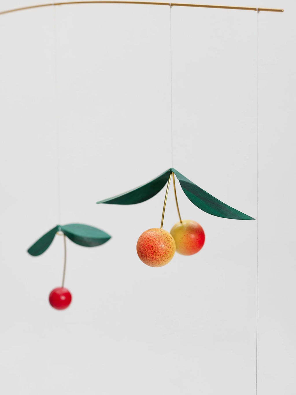 Decorative mobile with cherry design on a white background