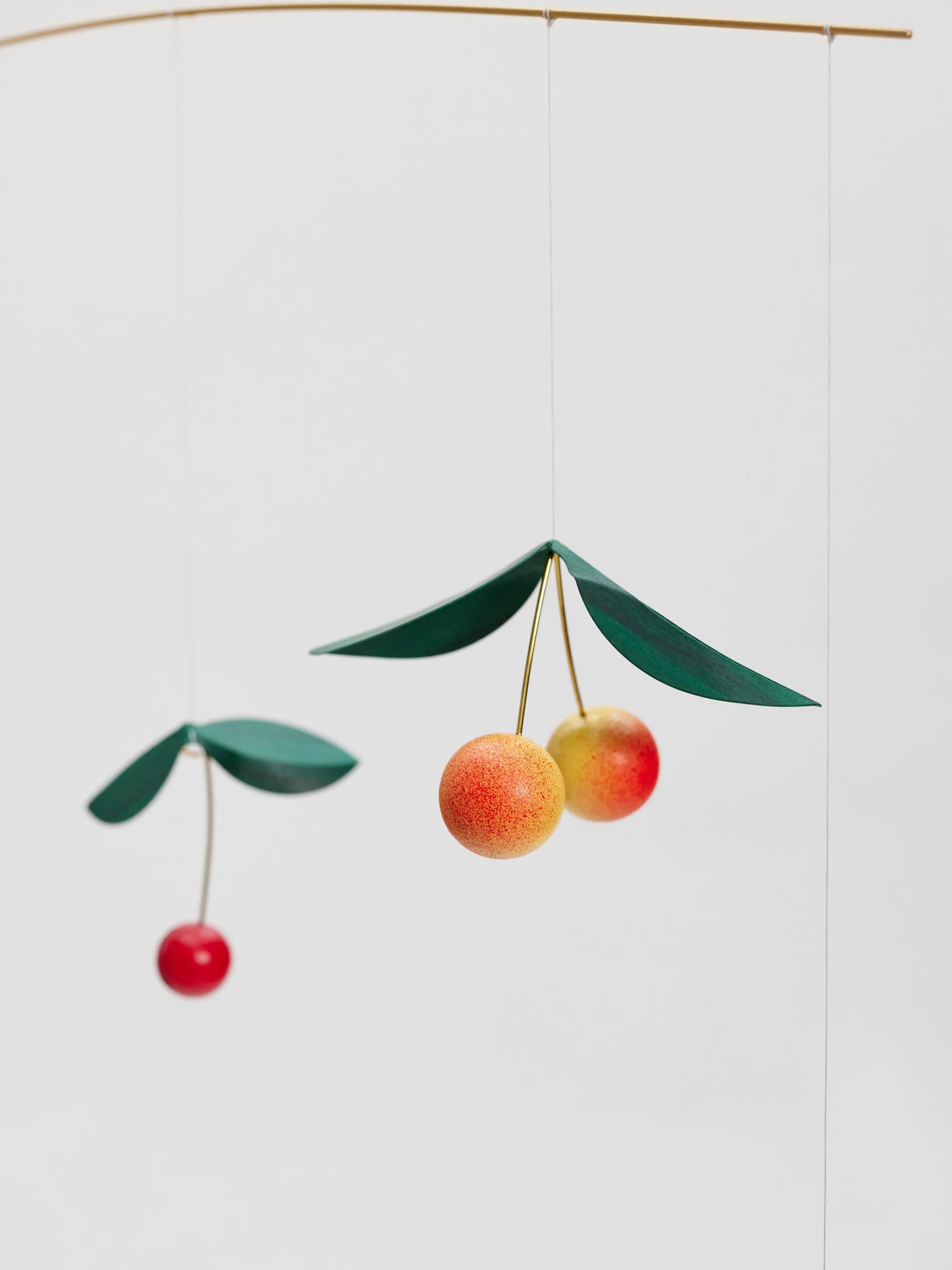 Decorative mobile with cherry design on a white background