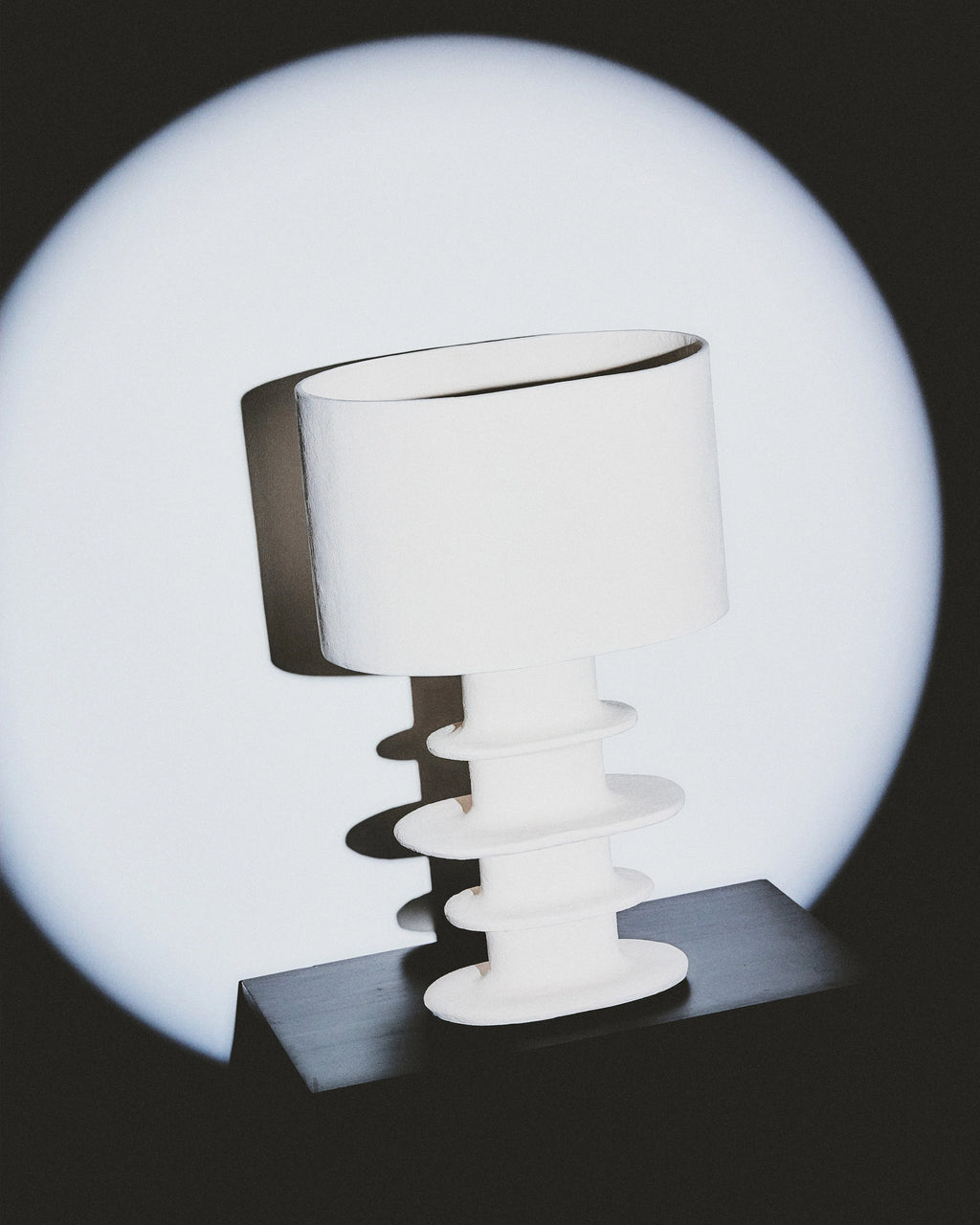 Organic geometrical white paper mache table lamp by Serax, featuring a hand-sculpted base and stunning illumination.