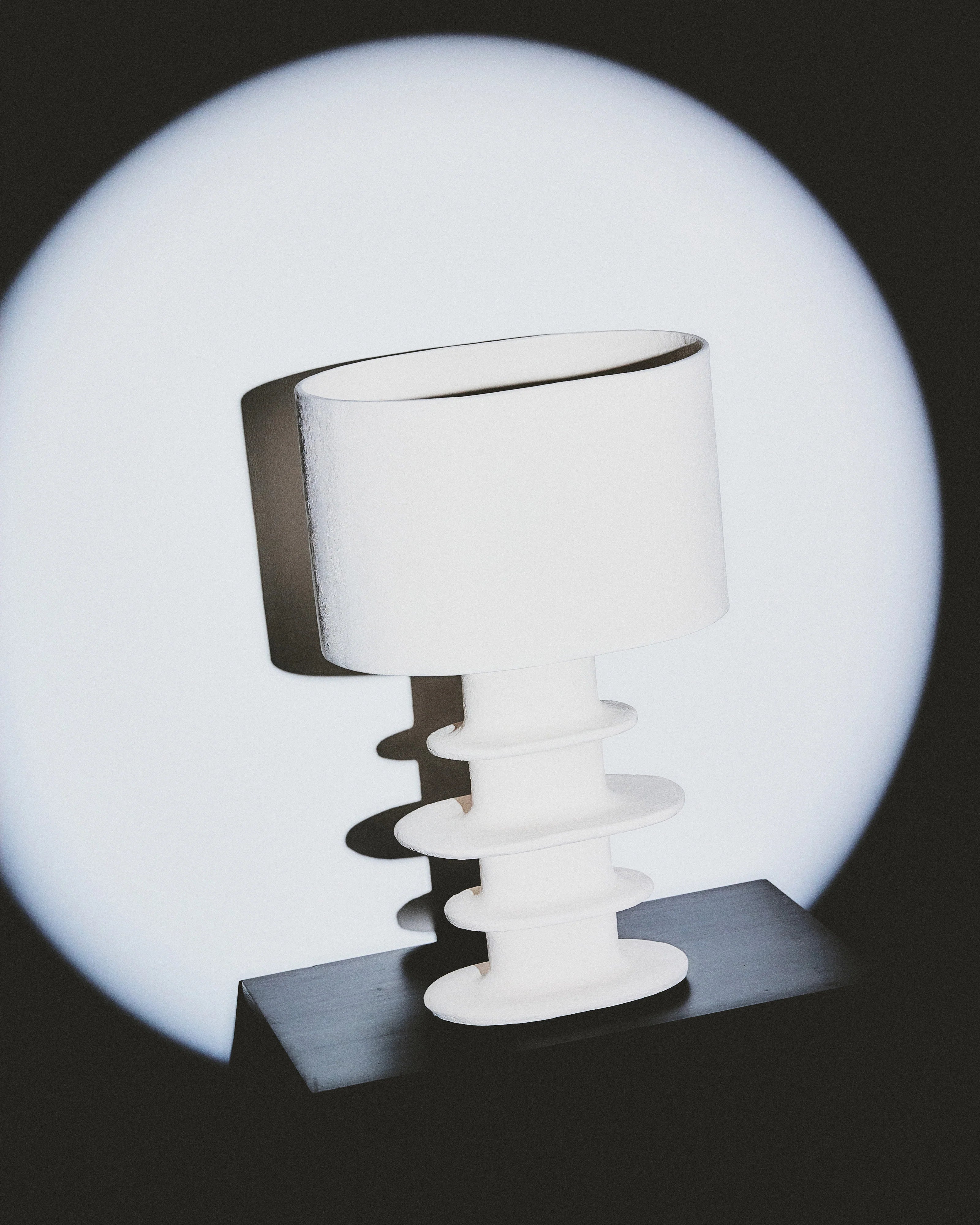 Organic geometrical white paper mache table lamp by Serax, featuring a hand-sculpted base and stunning illumination.