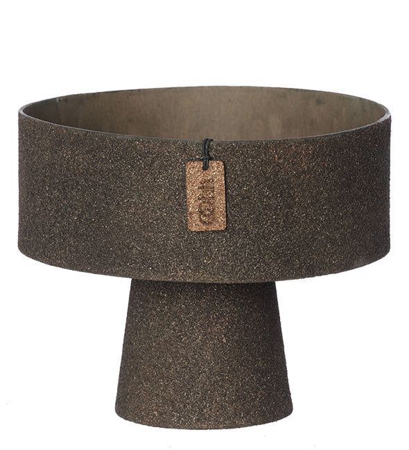 Brown textured pedestal bowl with a small tag on a white background