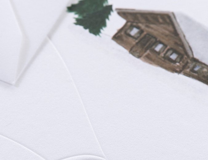 White envelope with a brown house and green tree illustration on a white background
