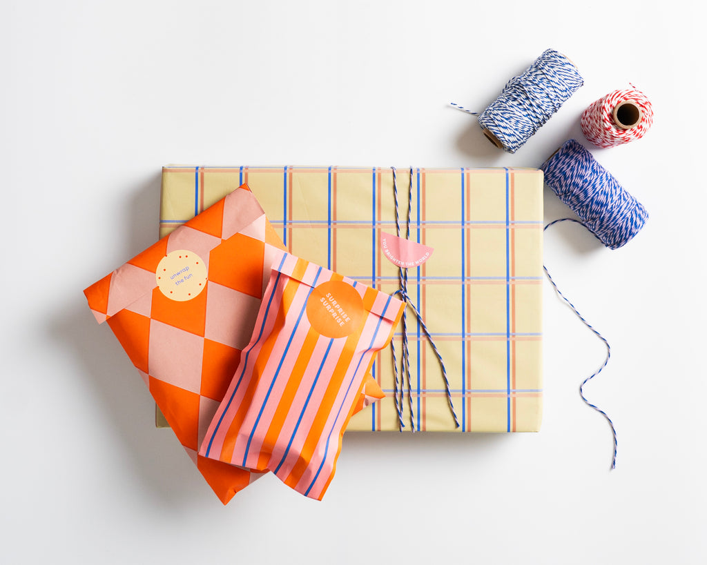 Norrska's minmal and modern gift wrap with colourful fabric and yarn on a white background