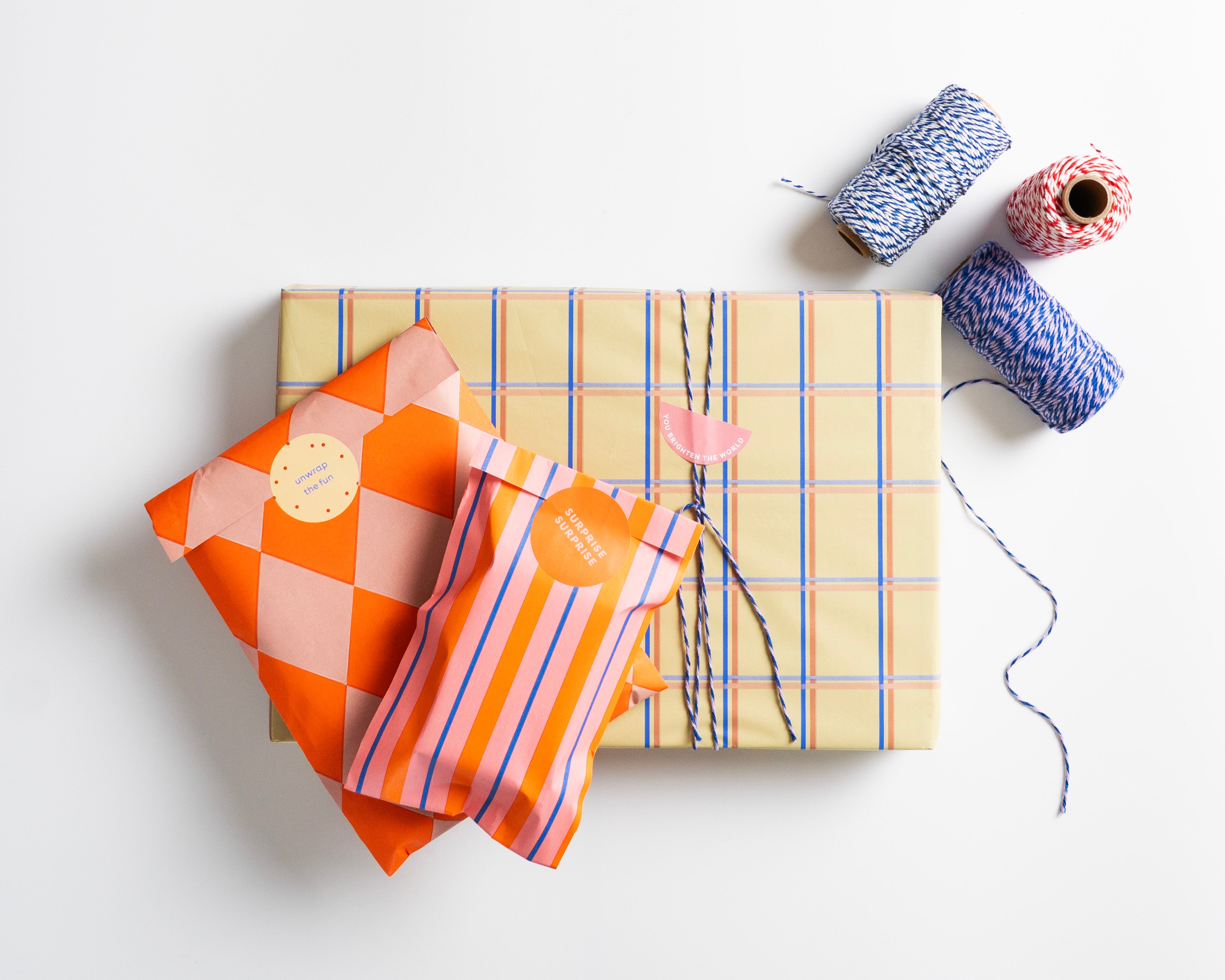 Norrska's minmal and modern gift wrap with colourful fabric and yarn on a white background