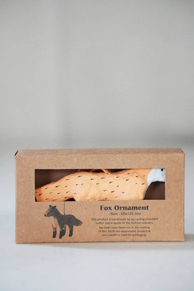 Boxed fox ornament with a clear window on a gray background